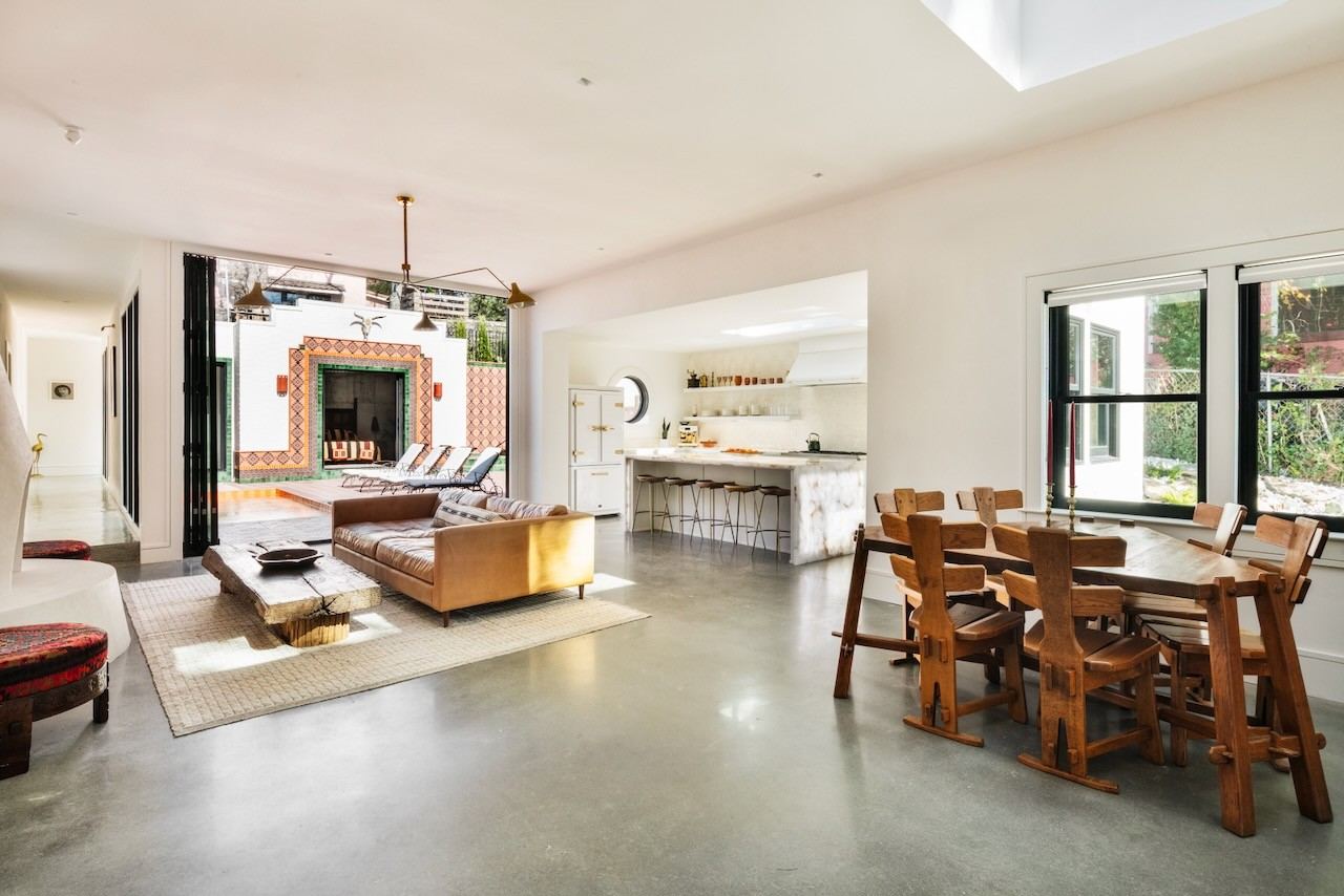 Distinctive living room opening to an outdoor terrace through wide doorways